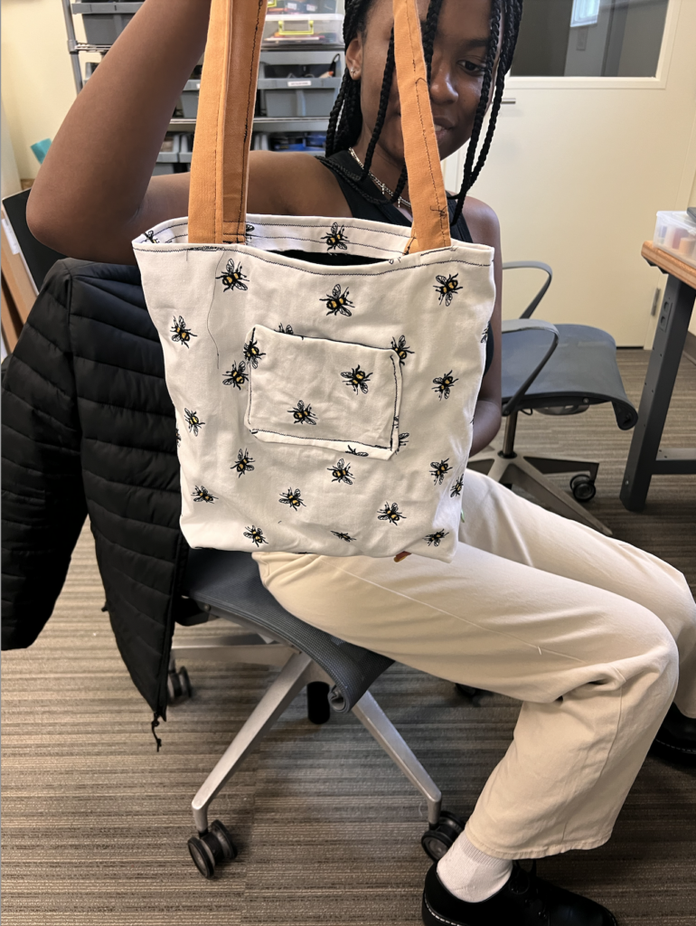 Young woman holding up completed tote bag