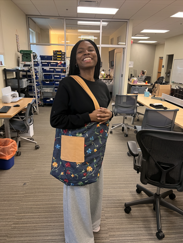 Young woman smiling with completed tote bag over her shoulder