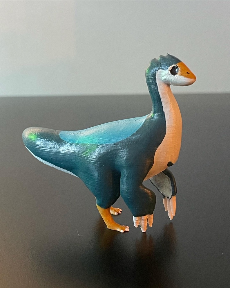 A 3D printed deinocheirus dinosaur that has been painted in blue colors