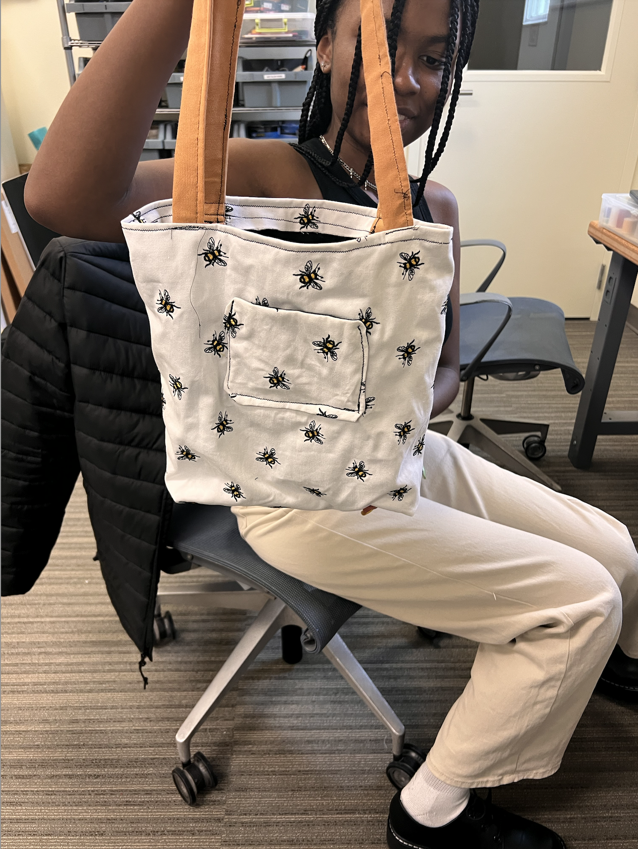 Young woman holding up completed tote bag
