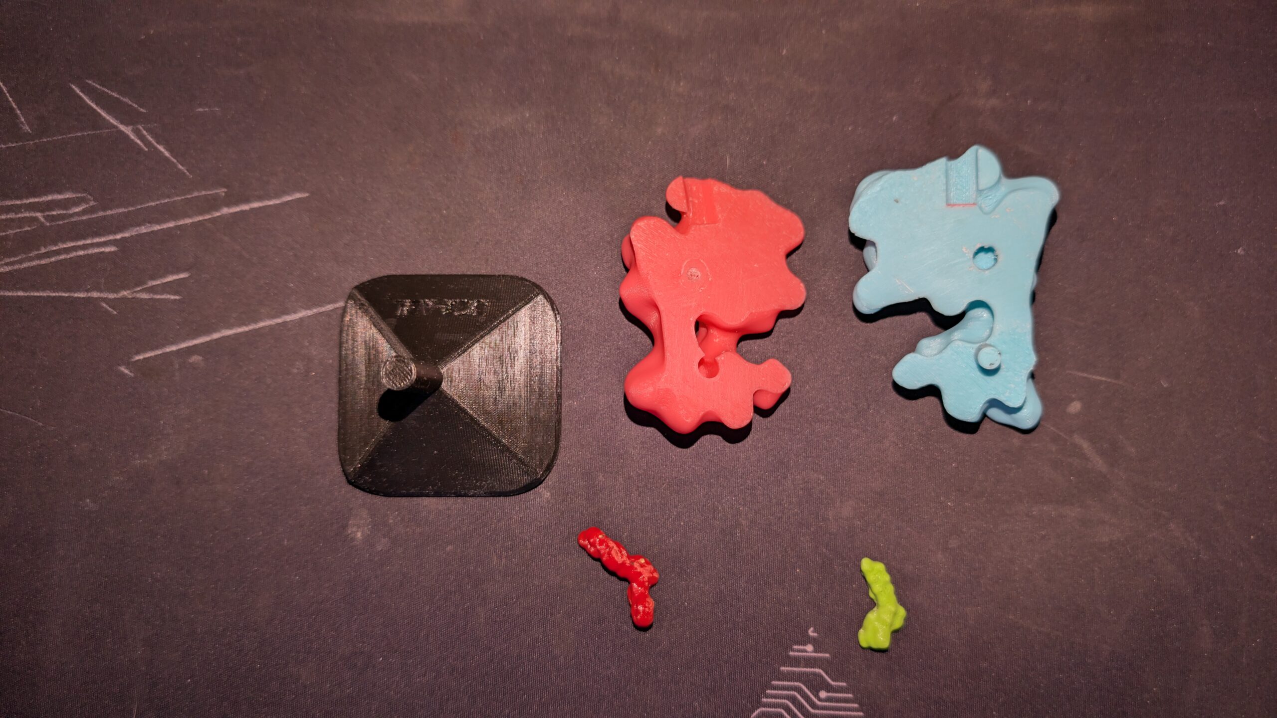 one half of a 3D printed molecule next to a stand, and smaller molecule