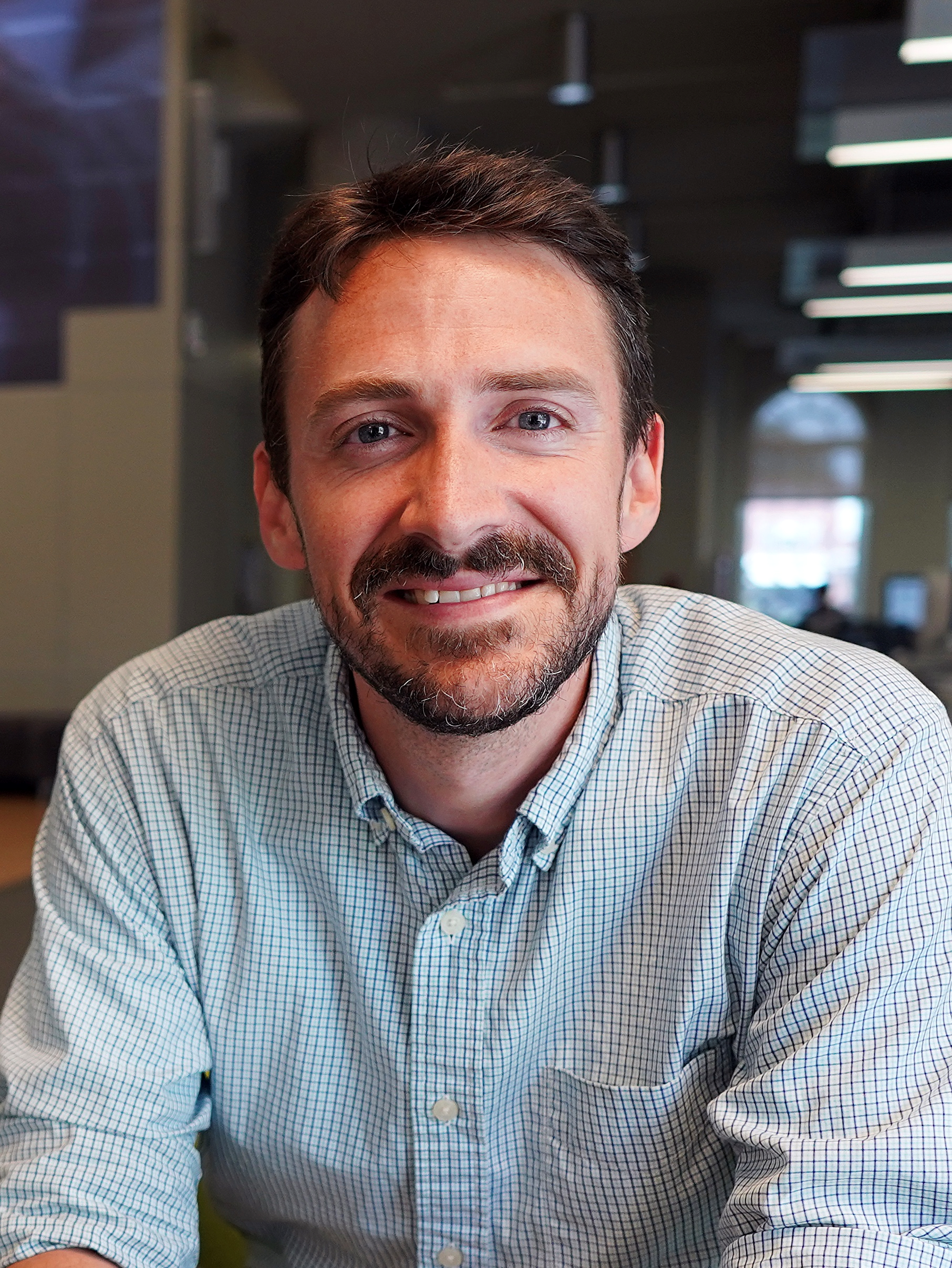 portrait of man with short brown hair and short beard